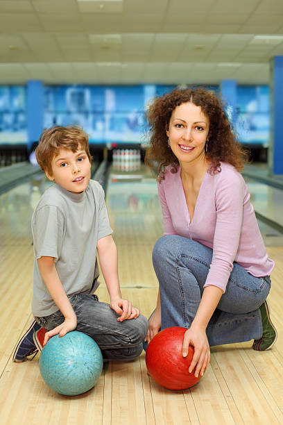 istock Mother and son keep balls ant sit in bowling club 177087823