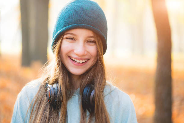 A young blond woman enjoying fresh air and natural fragrances in her garden.