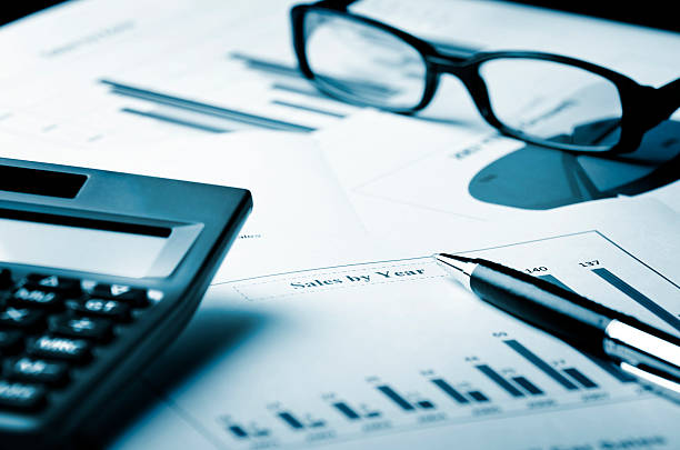 istock glasses, calculator and pen on a chart 177088167
