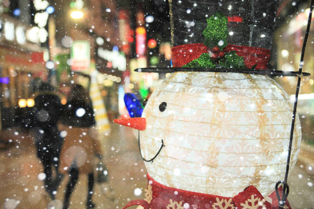 Outdoor Santa and Snowman decorations covered in snow