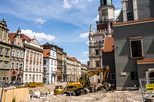Poznan, Poland - 05 July 2022: Old Market (Stary Rynek) square with small colorful houses, tourists and old Town Hall in Poznan, Poland. Square under reconstruction.