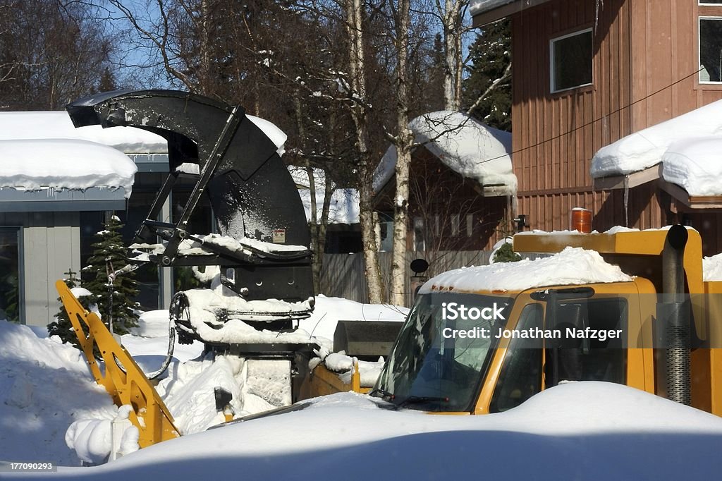 Snow Removal Truck Snow Removal Truck works through a residential area Alaska - US State Stock Photo