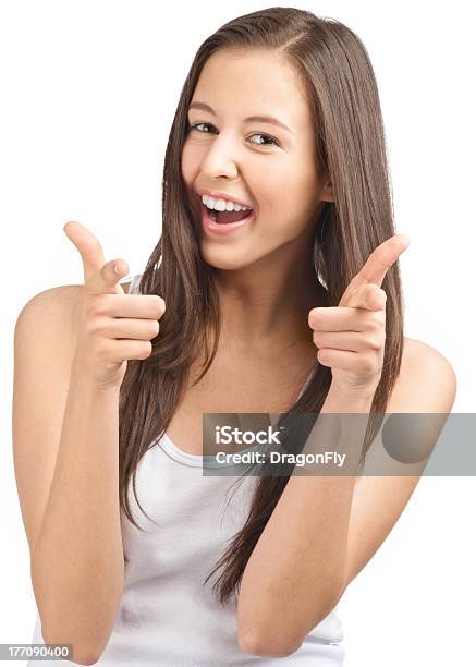 Happy Casual Girl Showing Thumbs Up And Pointing Stock Photo - Download Image Now - 20-29 Years, Adolescence, Adult