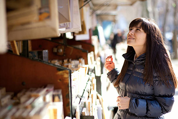 istock Beautiful woman in Paris selecting a book 177090469
