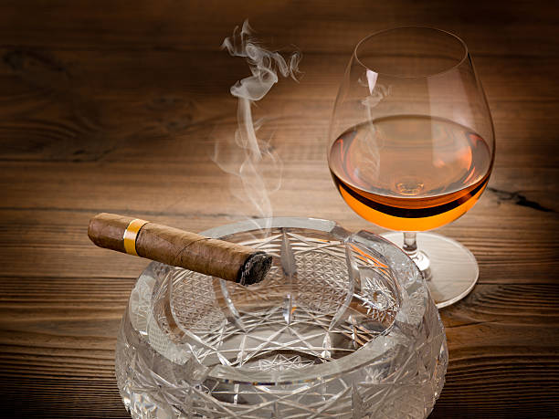istock smoking cuban cigar and alcoholic drink on wood background 177090495