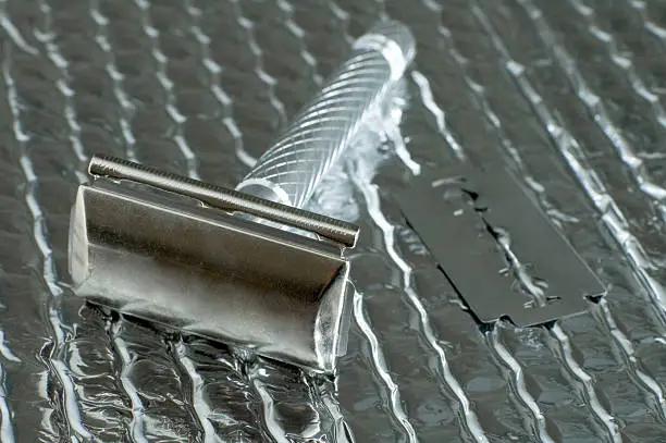 classic razor and a razor-blade on silver reflective background