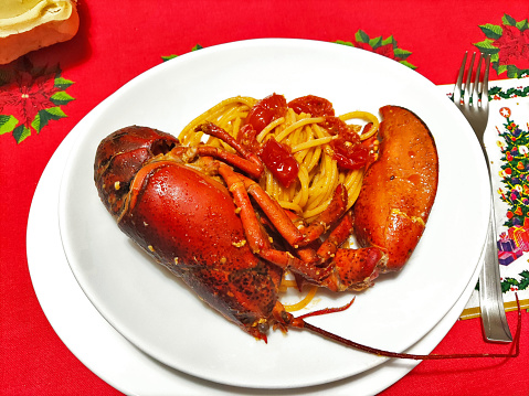 Oval Plate of spaghetti with lobster on a Christmas table