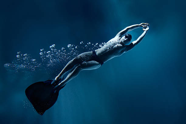 istock professional swimmer underwater with fin isolated on blue 177091156