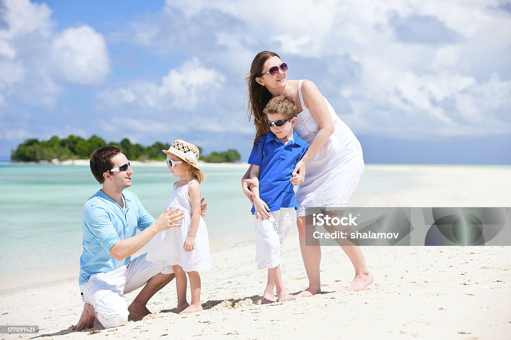 Happy family on tropical vacation Young beautiful family with two kids on tropical vacation Adult Stock Photo