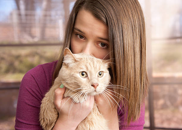 Young girl holding her cat