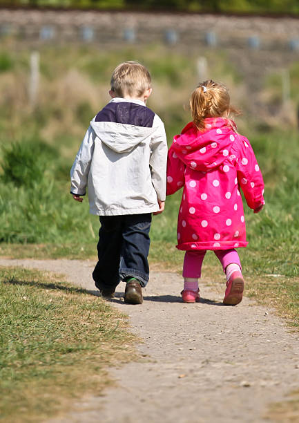 Brother and Sister enjoying the walk stock photo