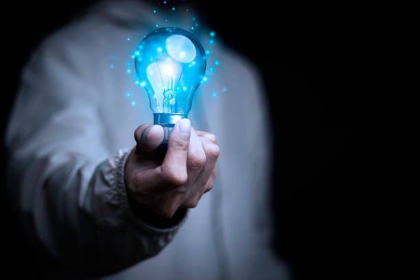 istock Businessman holding a light bulb creates new ideas. Innovation. Brainstorming. Solutions. And inspiration. Imagination. Creativity. Problem solving. Solution removing obstacles to success in business. 1770922230