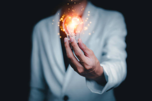istock Businessman holding a light bulb creates new ideas. Innovation. Brainstorming. Solutions. And inspiration. Imagination. Creativity. Problem solving. Solution removing obstacles to success in business. 1770922347