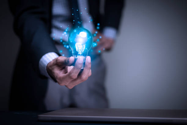 istock Businessman holding a light bulb creates new ideas. Innovation. Brainstorming. Solutions. And inspiration. Imagination. Creativity. Problem solving. Solution removing obstacles to success in business. 1770923198