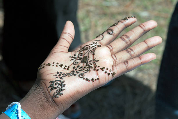 Work of tattoo artist on hand in India motif stock photo