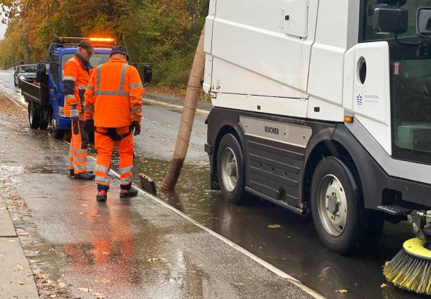 Two men working to unclog a drain following heavy rainfall in Scandinavia The photo was taken after heavy rainfall in Holte, a Copenhagen suburb on 31 October 2023. truck in rain stock pictures, royalty-free photos & images