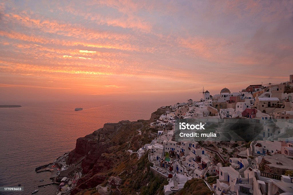 Famous Santorini sunset Santorini sunset in Ia village with the ship coming to the island Architecture Stock Photo