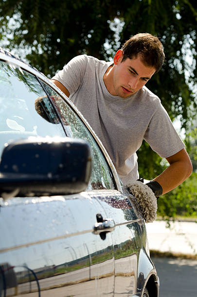 istock Young Man Cleaning A Car With Sponge 177093947