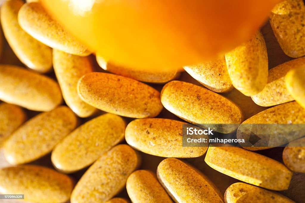 Vitamin Pills And Orange Macro Photo Of Orange And Vitamin Pils. Focus On Pills - Daylight. Beauty Stock Photo