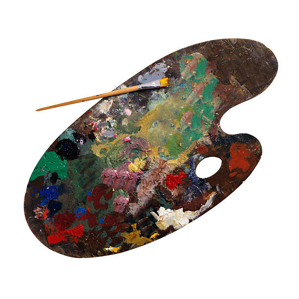 Wooden palette with paints and brush stock photo