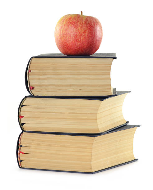 istock Stack of books and apple isolated on white 177095181