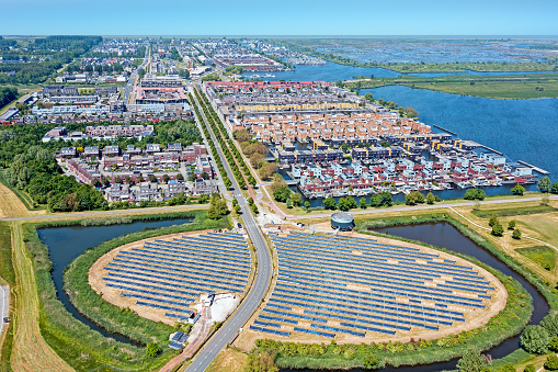 Solar Panel Farm with unique design in a form of an island (Zoneiland). Energy is used to power city heating (stadswarmte) in a modern sustainable district Noorderplassen in Almere, The Netherlands.