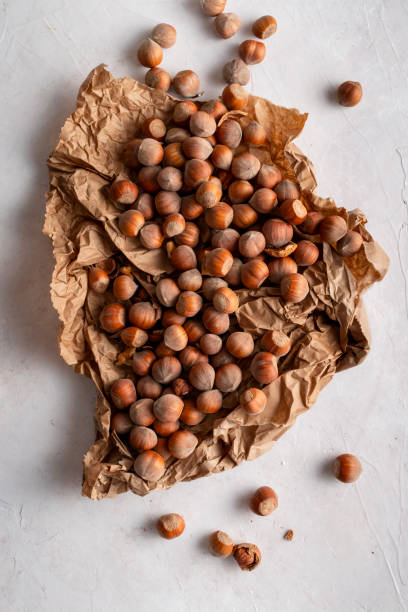istock Top view of hazelnuts on paper on delicate background. 1770956612