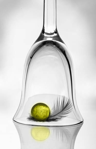 istock Wineglass, yellow ball and feather 177096512