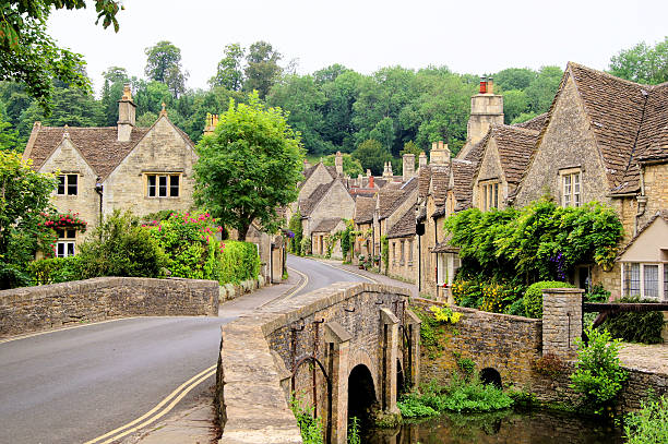 Traditional Cotswold village, England Picturesque Cotswold village of Castle Combe, England village stock pictures, royalty-free photos & images