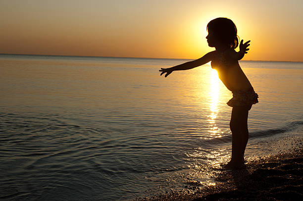 istock Kid's silhouette on sunset beach 177096874