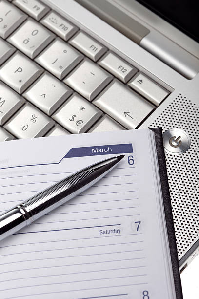 istock Silver lap top and pocket planner close up 177097497
