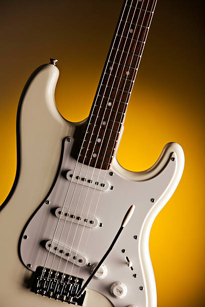 istock White Guitar Isolated On Yellow Spotlight 177098108
