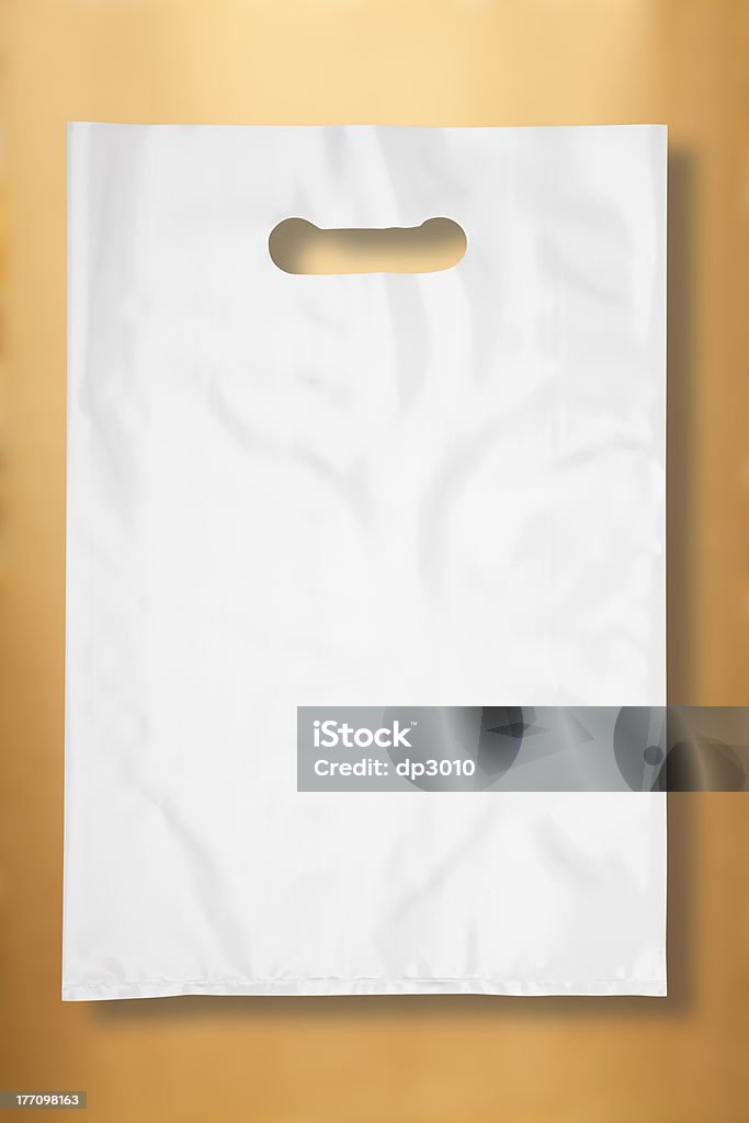 Busta di plastica su gold - Foto stock royalty-free di Bianco