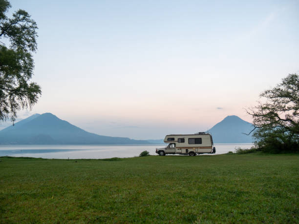 Budget travel concept, RV vacations on the lakeshore, volcano view