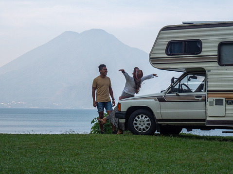 Budget travel concept, RV vacations on the lakeshore, volcano view