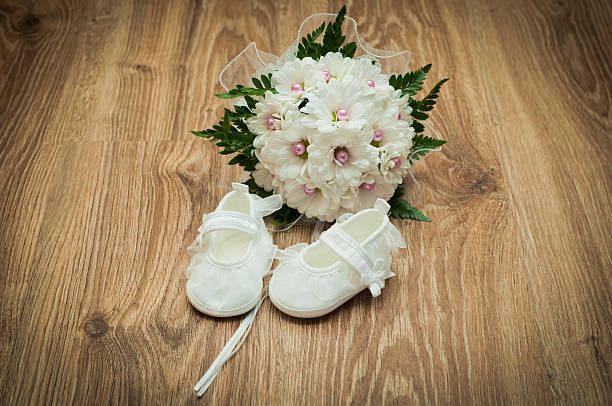 shoes and bouquet on a wooden floor stock photo