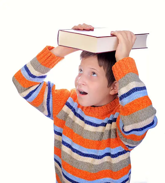 Student child with a book on his head isolated over white