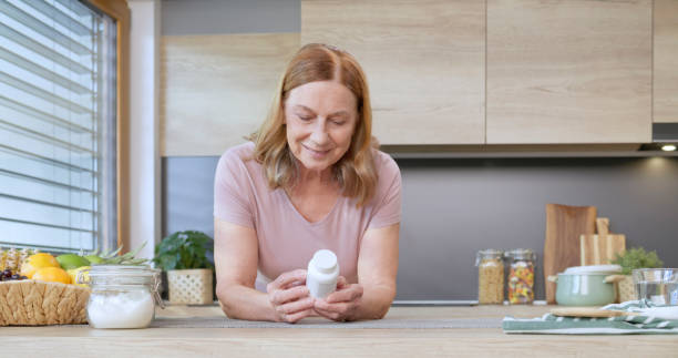 istock Woman holding pill bottle 1770997649