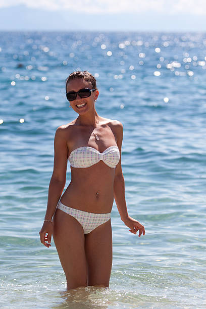 Pretty young woman wearing bikini in water stock photo