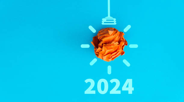 istock 2024 and paper light bulb on blue background 1771000307