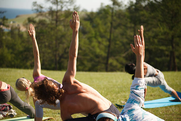 Yoga practicing outdoors stock photo