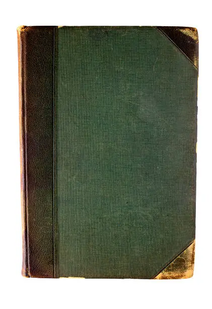 The front cover of an old, green leather-bound book with leather corners, scuffed and scratched from years of use and misuse. Suitable as a background. Clipping path included.