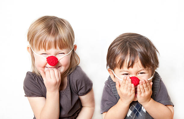 Two kids playing Reindeer cute and funny boy and girl having fun playing reindeer with fake red nosesSiblings & Cousins: rudolph the red nosed reindeer photos stock pictures, royalty-free photos & images