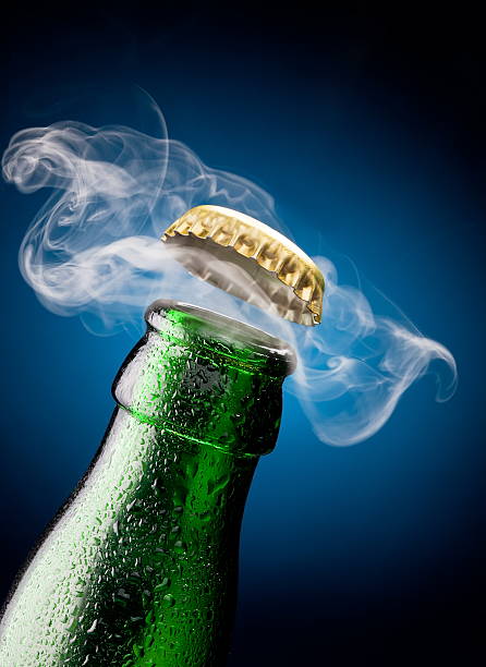 Opening of beer cap Opening of beer cap with the gas output opening bottle cap photos stock pictures, royalty-free photos & images