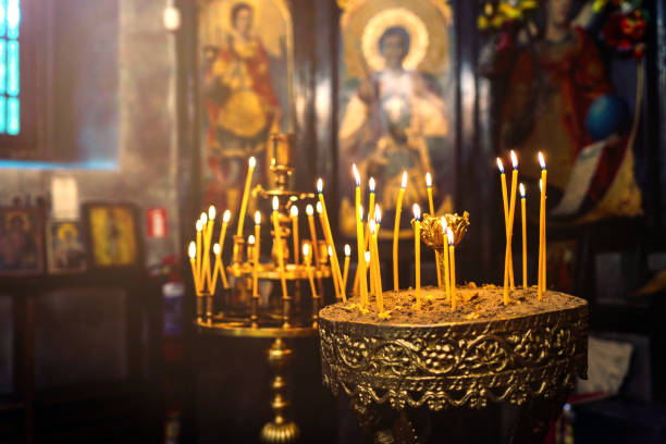 A lot of candles in the orthodox church near the altar stock photo