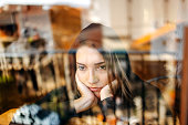 Young depressed woman home alone looking sad