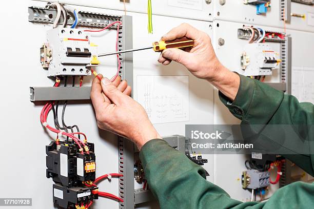 Workers Hands With Screwdriver Working On Electric Panel Stock Photo - Download Image Now