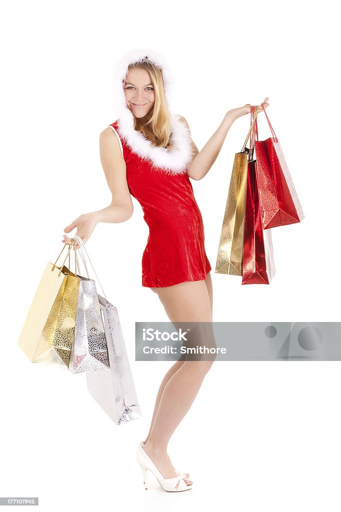 christmas woman shopping happy young woman in santa suit carrying shopping bags Adult Stock Photo