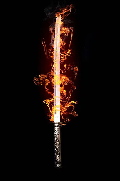 Japanese sword in flames on a black background