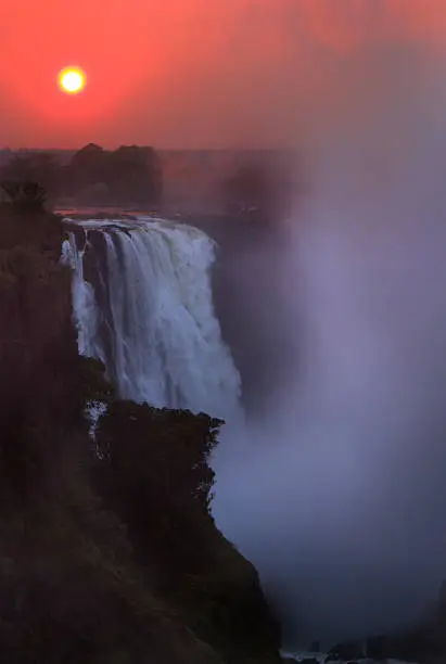 The falls at sunrise with the sun in the background